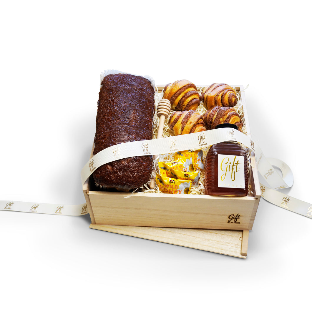 Rosh Hashanah Bakery and Honey Gift Box with honey cake, rugelach, honey, honey dipper, and candies in a wooden crate.