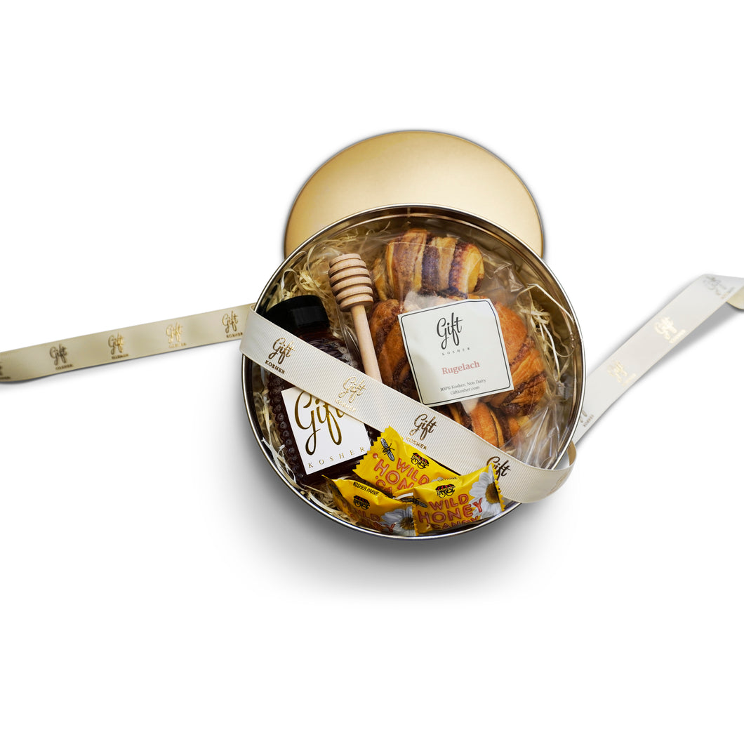 Rosh Hashanah Honey and Rugelach Gift Tin with rugelach pastries, bottle of honey, wooden dipper, and honey candies in a gold tin.
