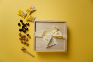 Rosh Hashanah Sweet Gift Box tied with Gift Kosher ribbon, featuring chocolates, honey candies and nuts for the Jewish New Year
